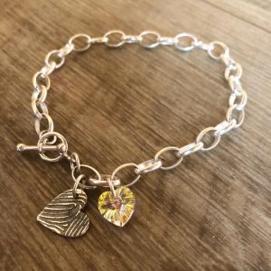 1 Fingerprint charm bracelet. Chunky chain with hoop & T-bar clasp and heart crystal