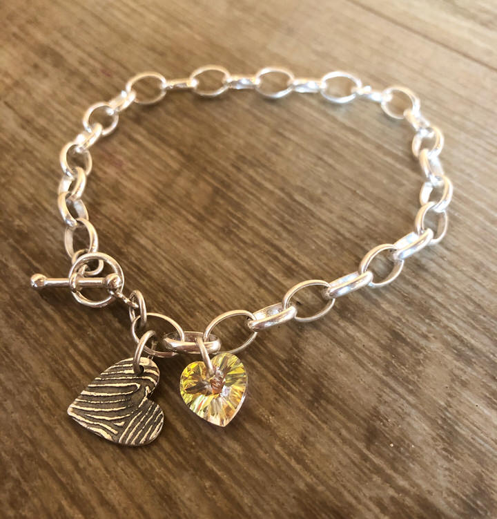 1 Fingerprint charm bracelet. Chunky chain with hoop & T-bar clasp and heart crystal